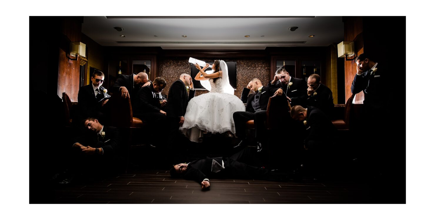 best nj wedding photographer, Lisa Rhinehart, captures this fun, unique, creative image of the bride as she drinks with the rest of the groomsman passed out around her during this palace at Somerset Park wedding reception in New Jersey 