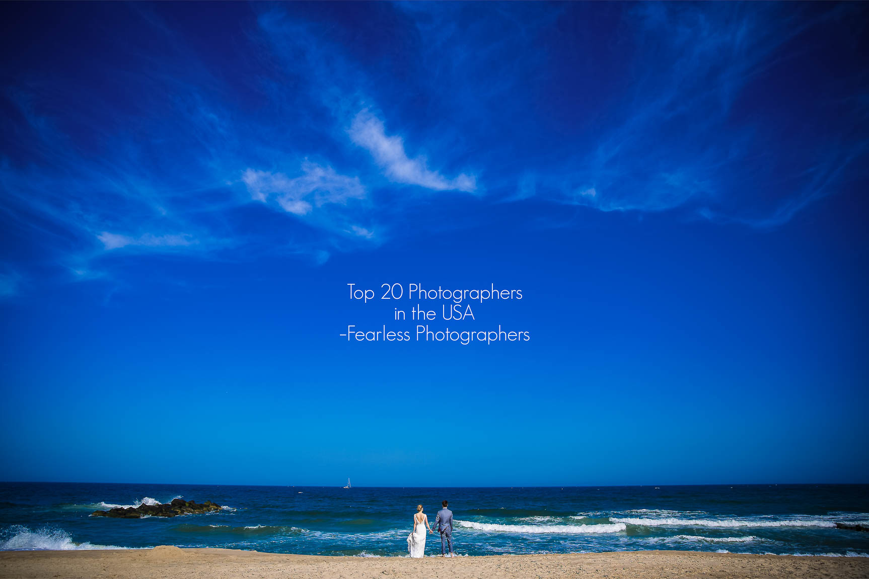 Top 20 USA Wedding Photographer, Lisa Rhinehart, captures this vibrant, colorful image of the bride and groom holding hands as they watch the ocean during their wedding ceremony in Spring Lake, NJ