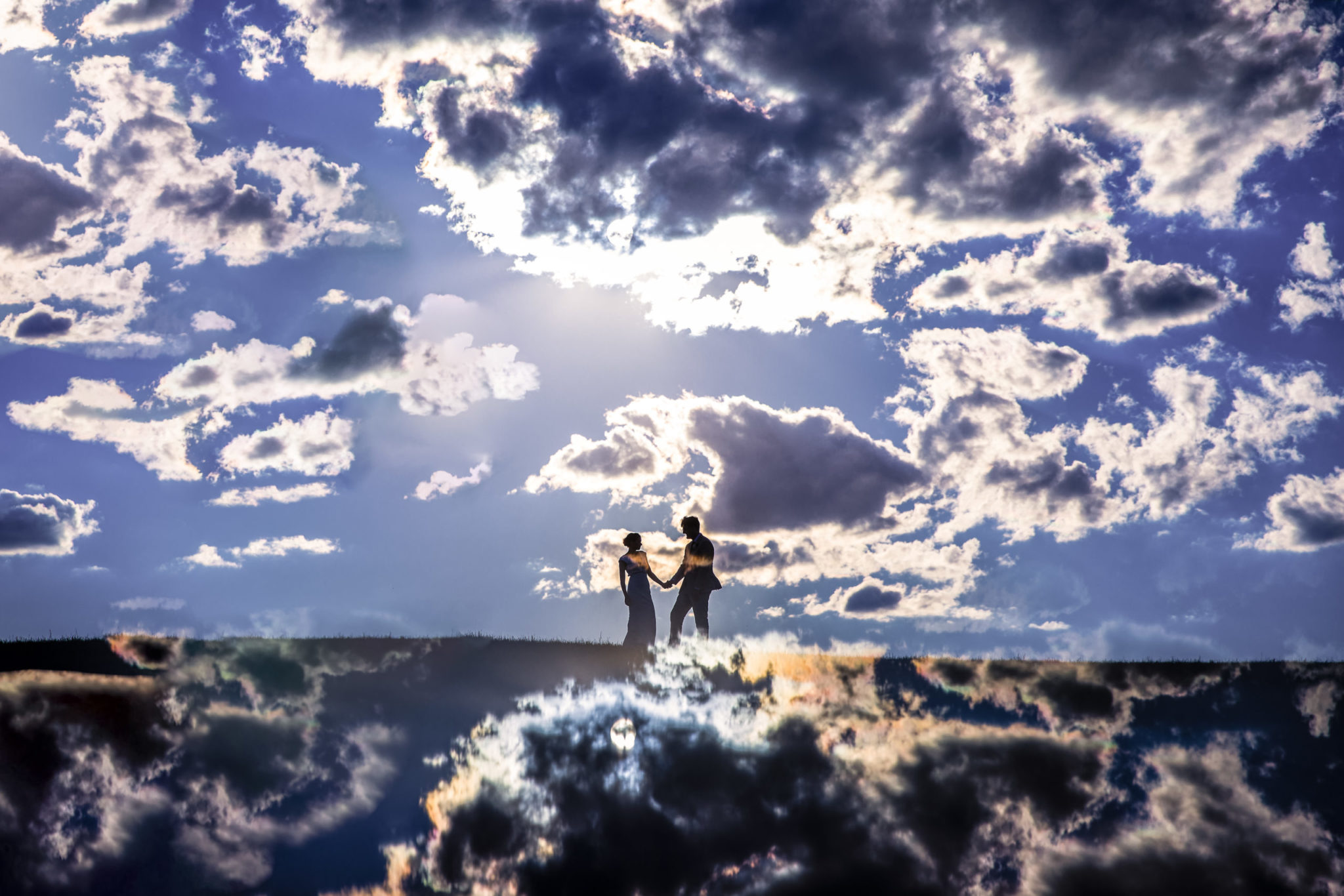Central PA wedding photographer captures this creative, unique of a couple as they hold hands surrounded by clouds