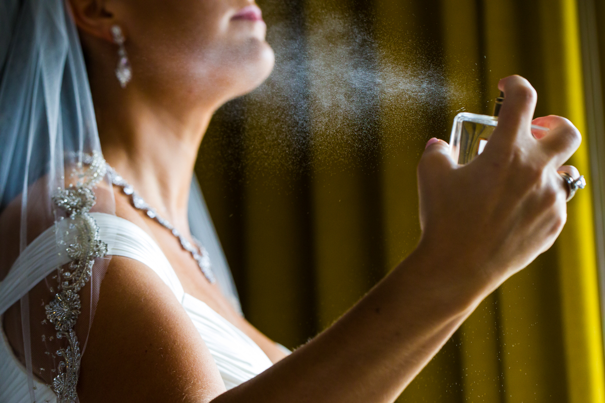 Bride spraying perfume in the darcy hotel in washington dc luxury wedding