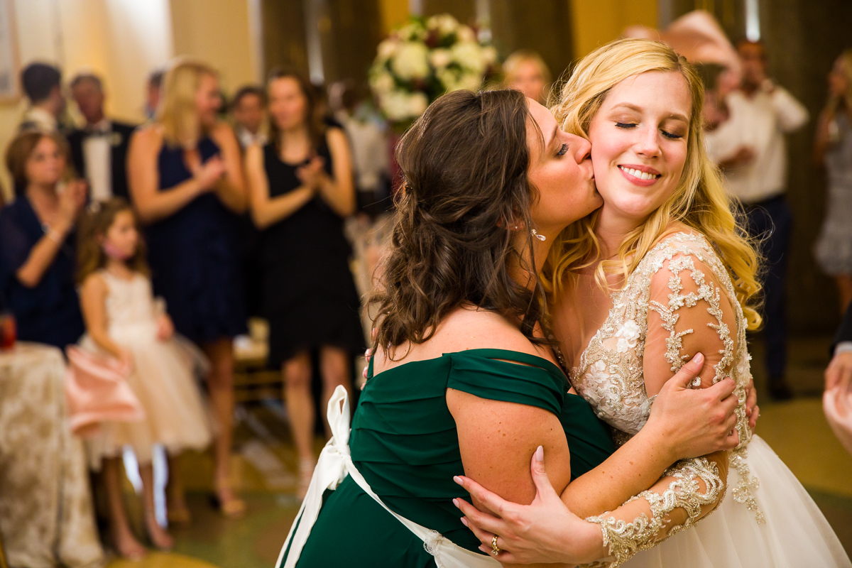 maid of honor kisses bride during polish shot glass Pittsburg wedding tradition