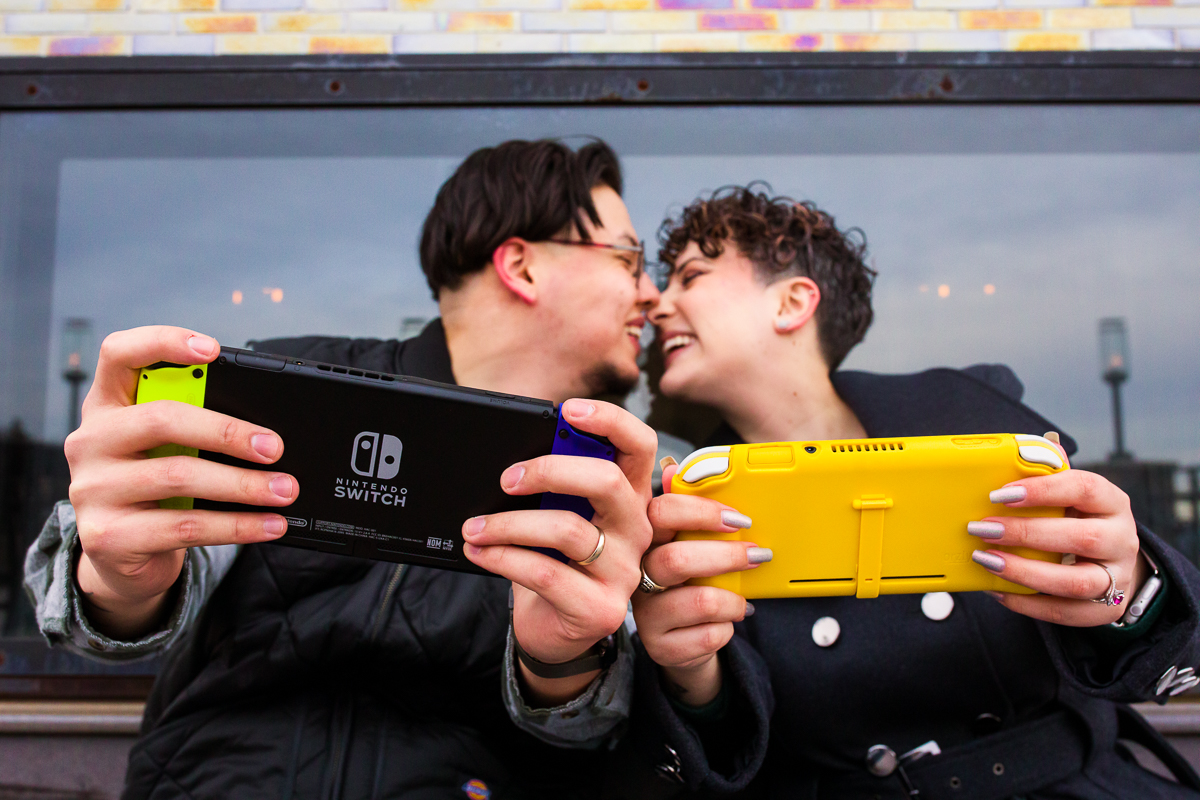gamer engagement photography session couple holding yellow nintendo switch 