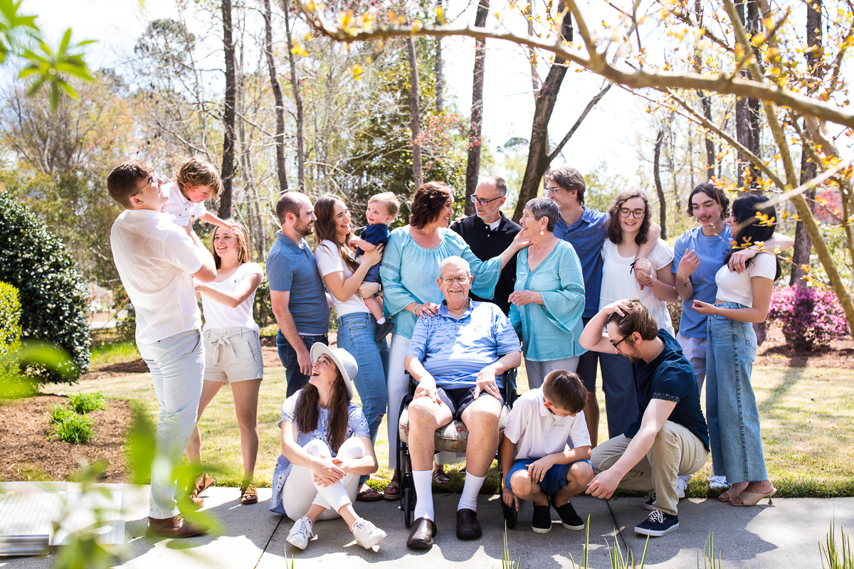 authentic family vacation photographer captures real life creatively award winning best extended family portraits grandparents children grandchildren gather in blue and white outside