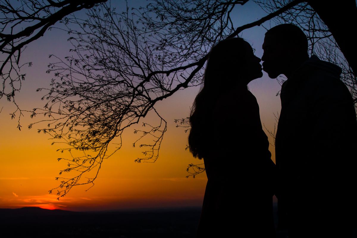 Engaged couple Silhouetted against the sunset of the pagoda in reading PA