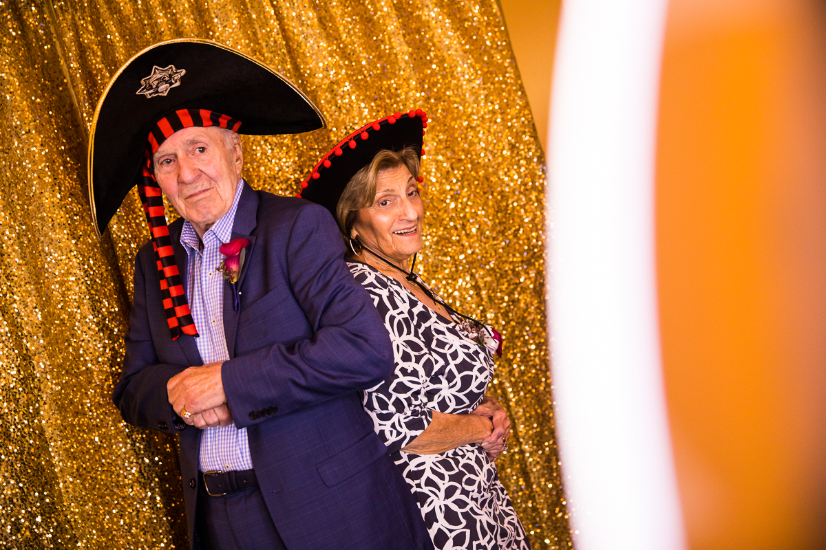 grandparents at photo booth with pirate hats