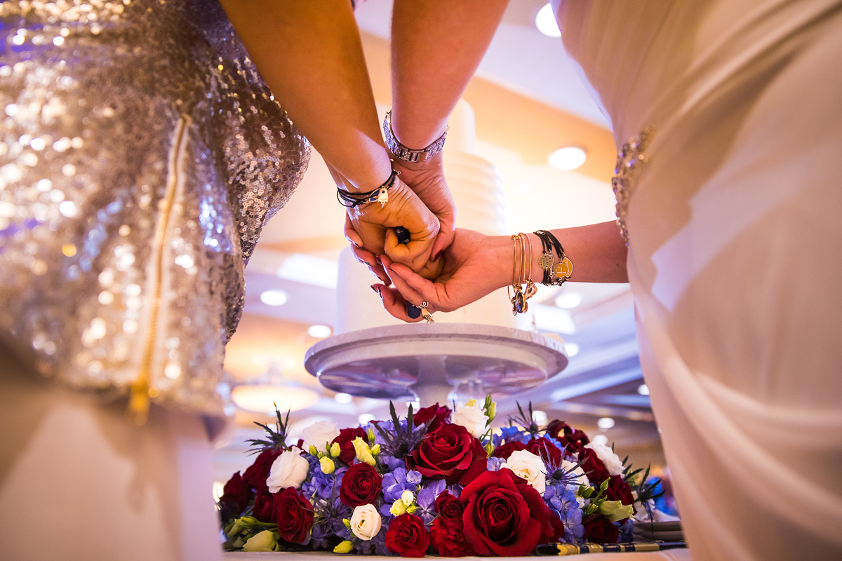 unique perspective of brides cutting wedding cake