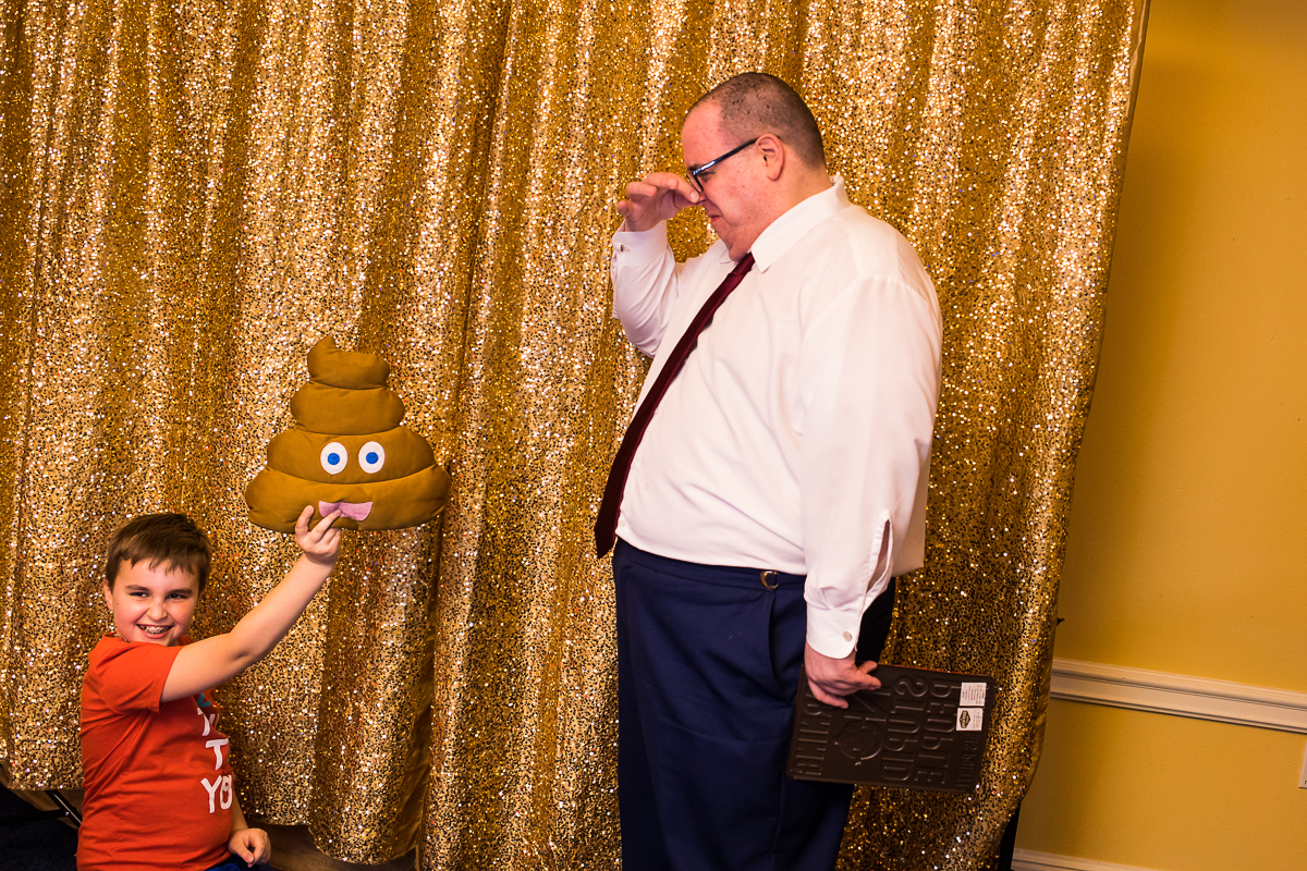 guest holding poop emoji Photo Booth prop