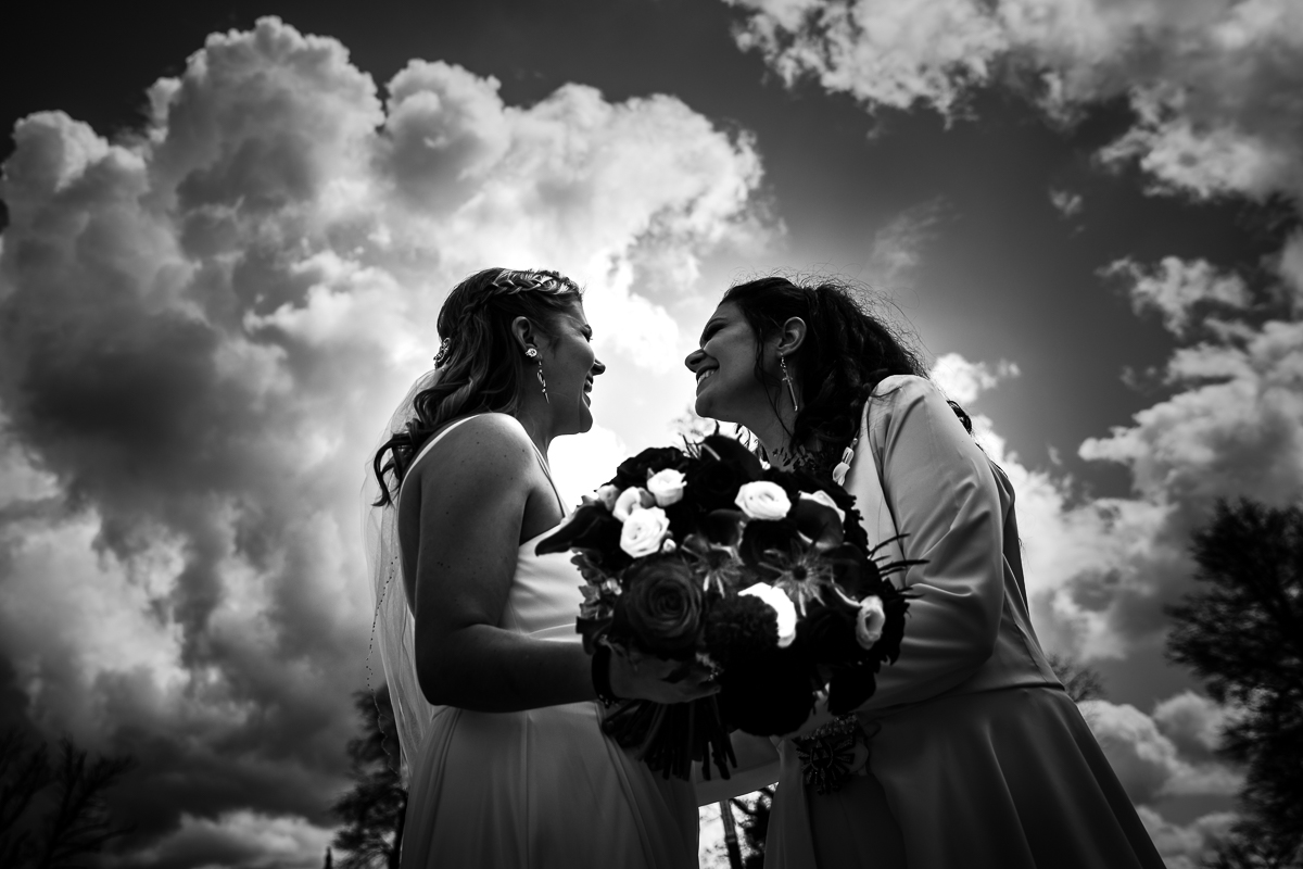 two brides sharing first look on their wedding day black and white