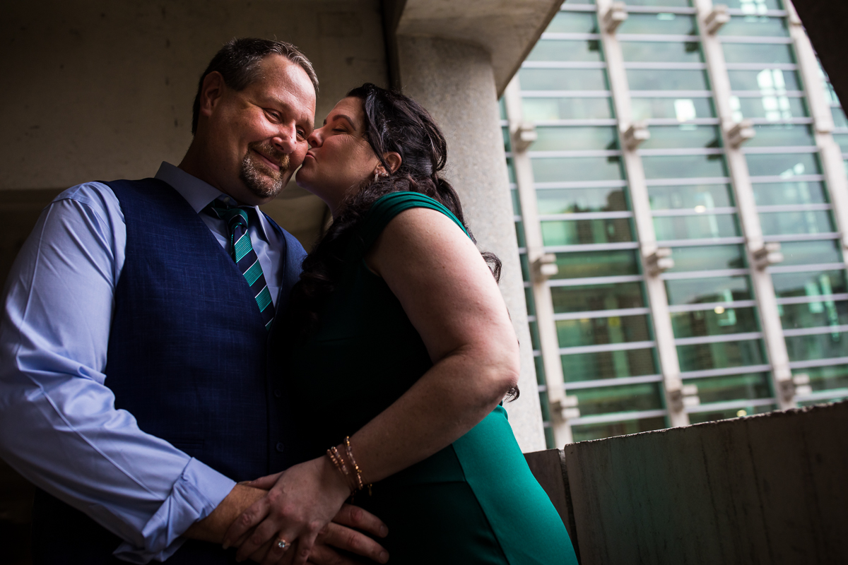 harrisburg engagement photographers creative best woman in green dress giving man kiss on cheek