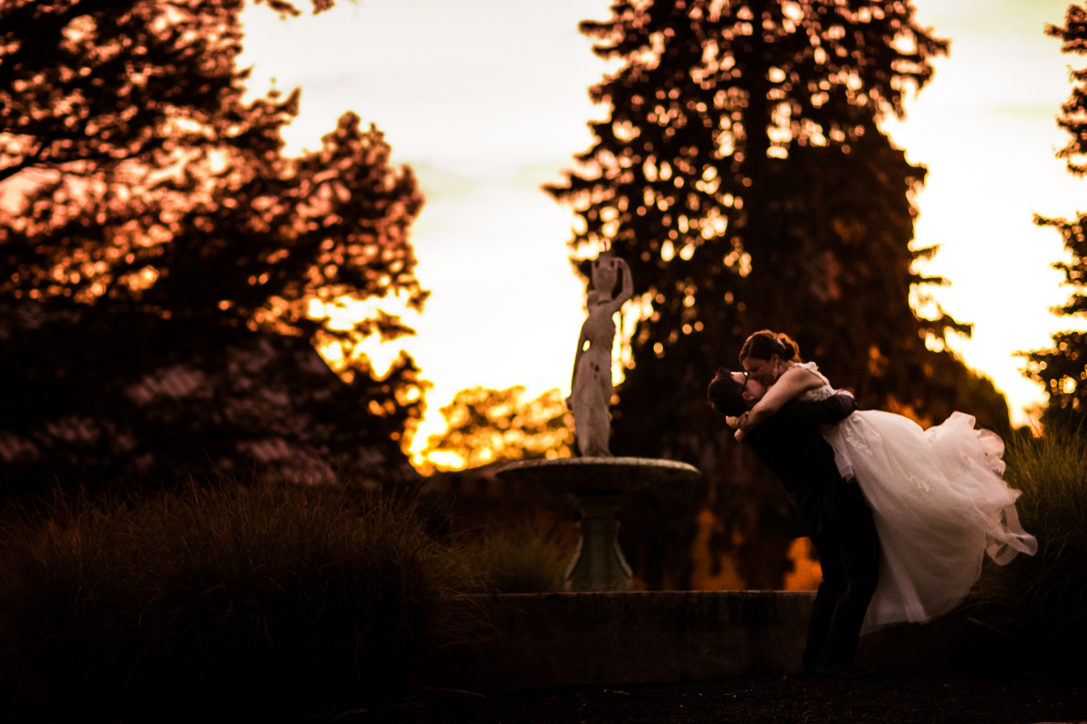 mount hope estate wedding photographer bride and groom kissing behind fountain in Manheim pennsylvania best wedding photographer