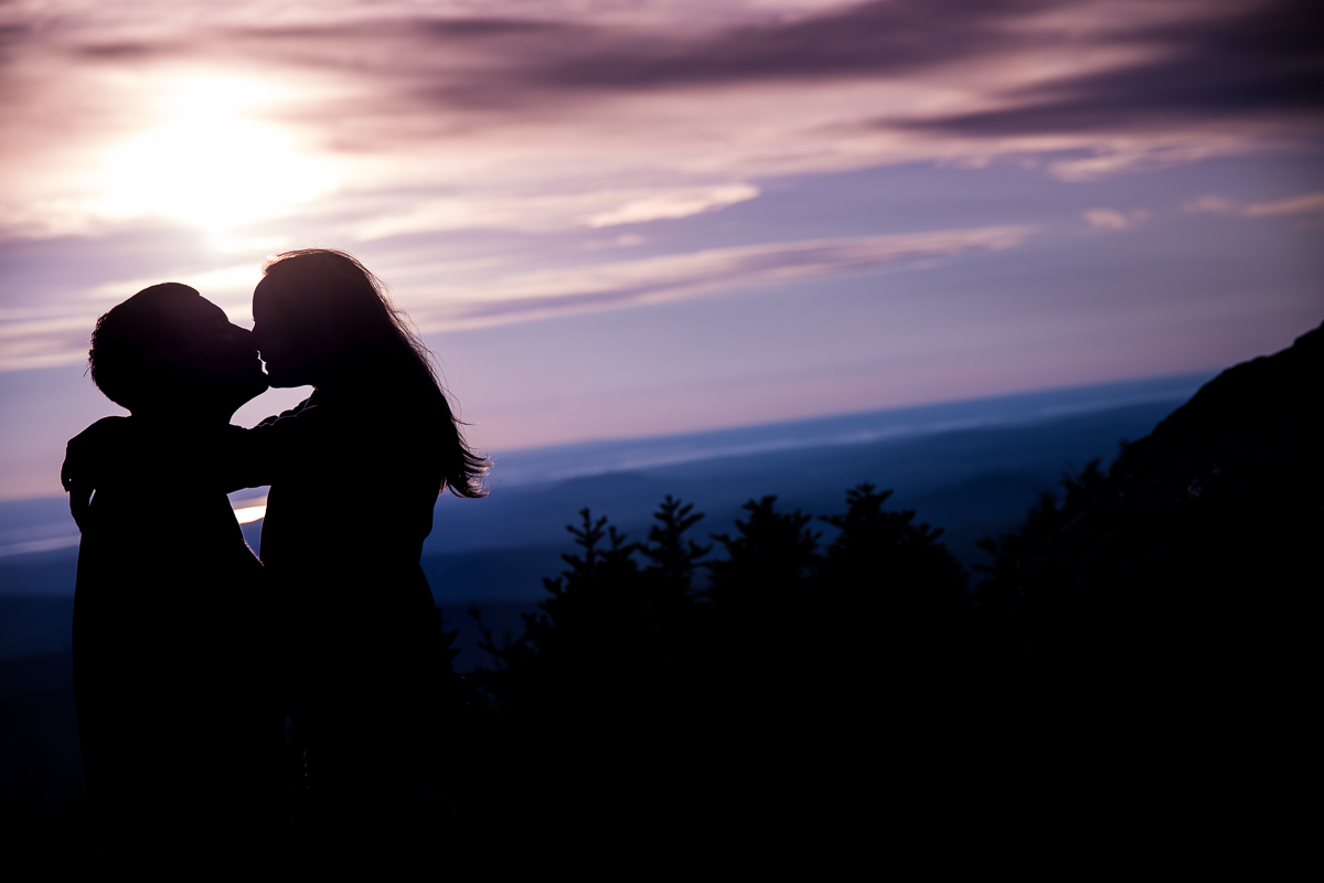 couple kissing silhouetted against sunset on top of mountain creative vibrant artistic photographer central pa outdoor lifestyle photographer