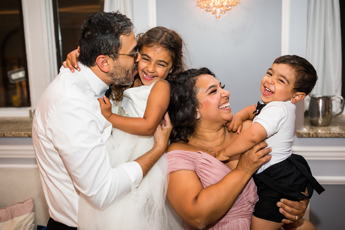 family smiles and laughs while posing for photo during wedding reception best pa family photographer authentic candid