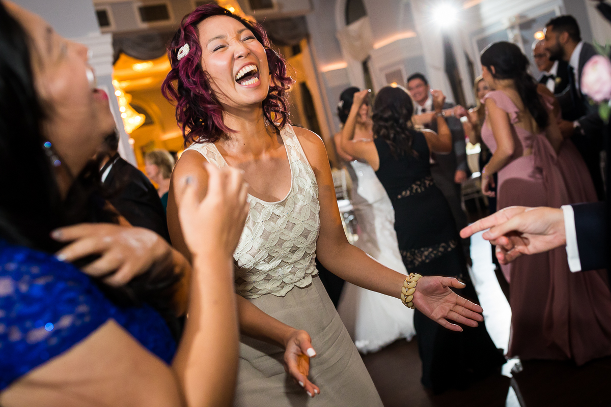 guests laughing and dancing during wedding reception