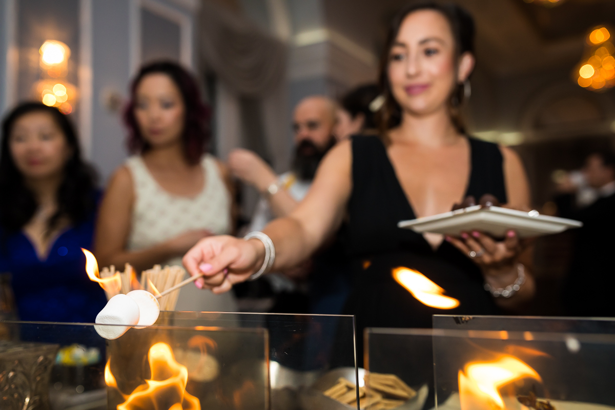 arts ballroom Philadelphia wedding stores bar during wedding reception girl roasting marshmallow over open fire