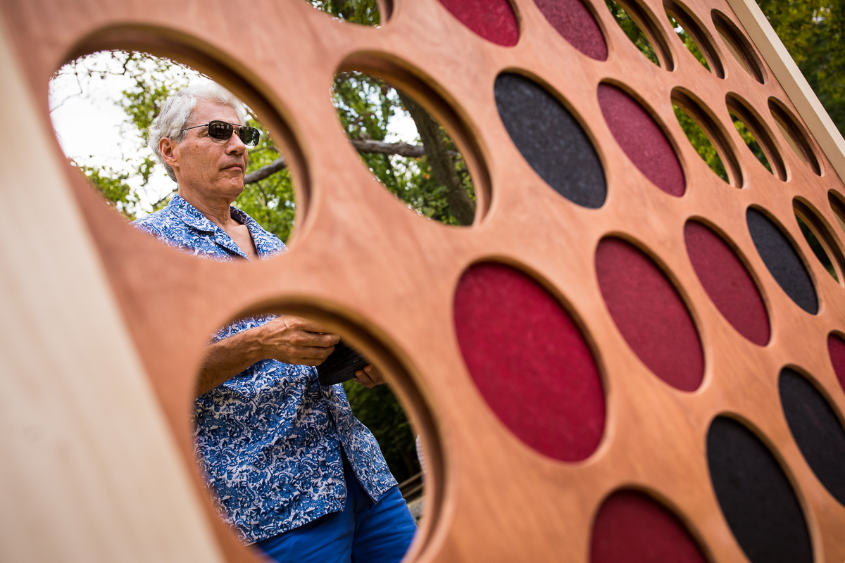 man standing behind giant connect four game outside at bluemont park wedding celebration creative photographer 