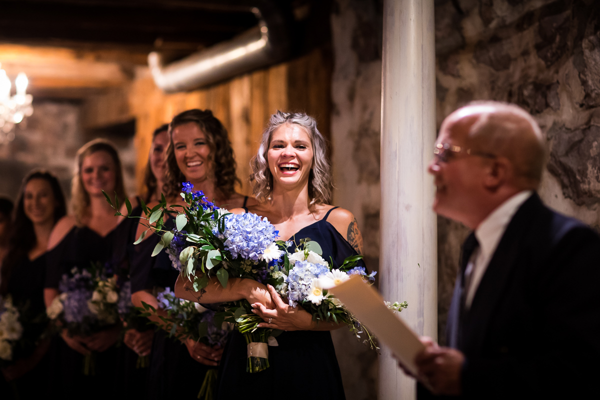 joyful emotional wedding ceremony bridesmaid laughs at officiant