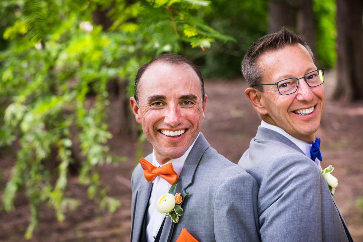 two grooms smiling at the camera during portrait time authentic natural vibrant wedding photographer central PA DC 
