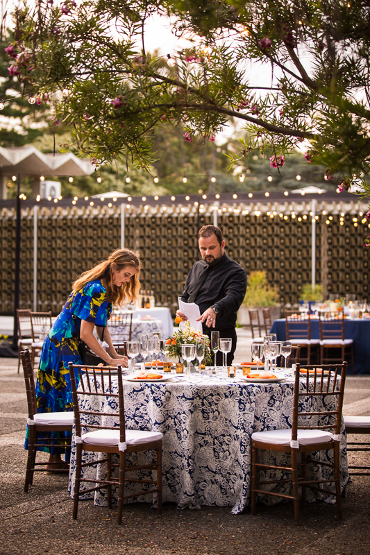 colorful national arboretum wedding decor blue tablecloths orange napkins vendors putting final touches
