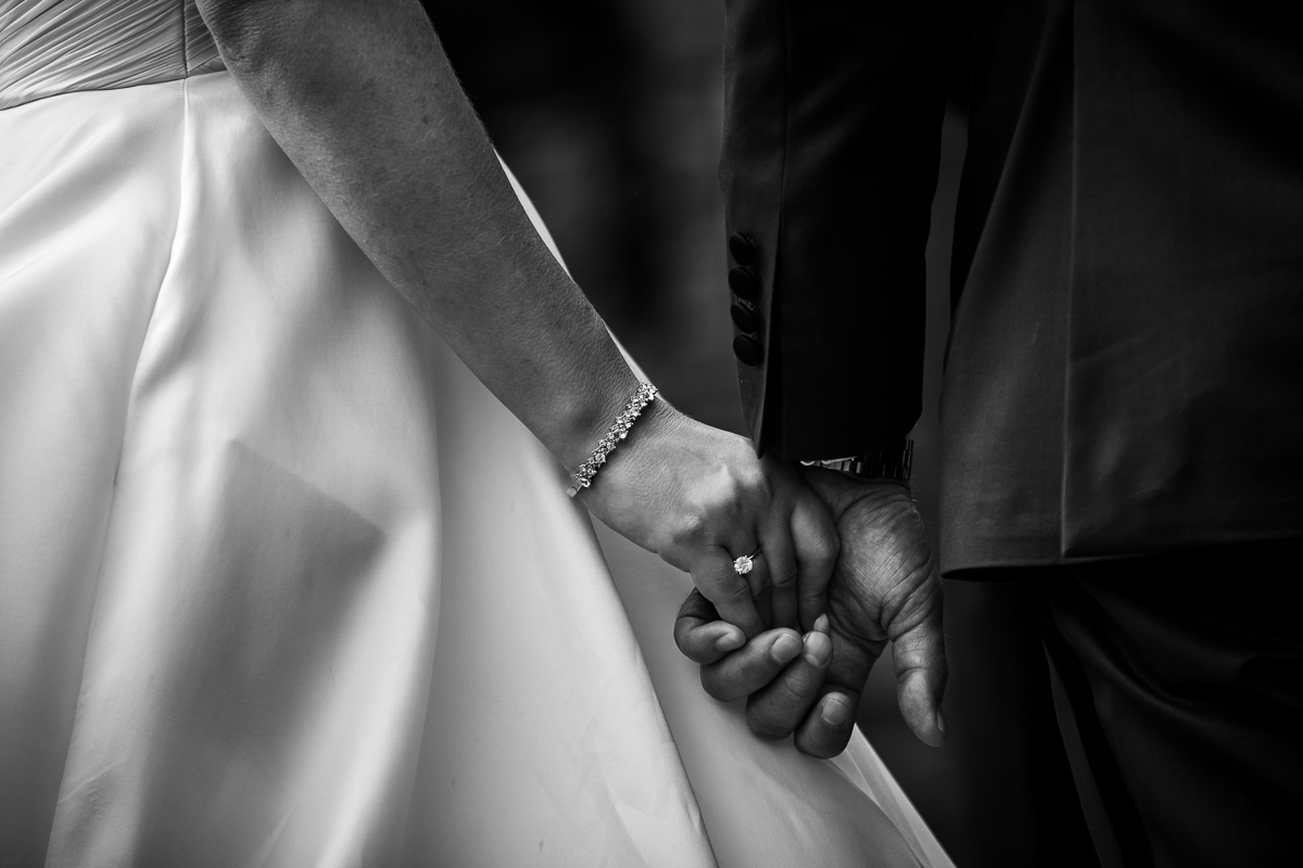 best award winning wedding photographer detail shot of brides wedding rings and bracelet during ceremony