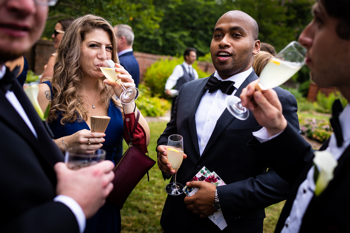 river farm Virginia wedding cocktail hour guests sip champagne while enjoying snacks before reception