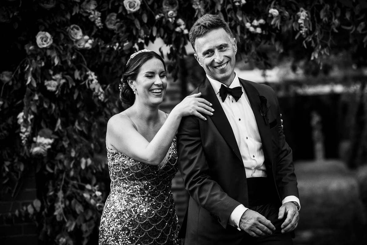 best award winning river farm wedding photographer black and white photo of bride touching grooms shoulder in gardens both smiling