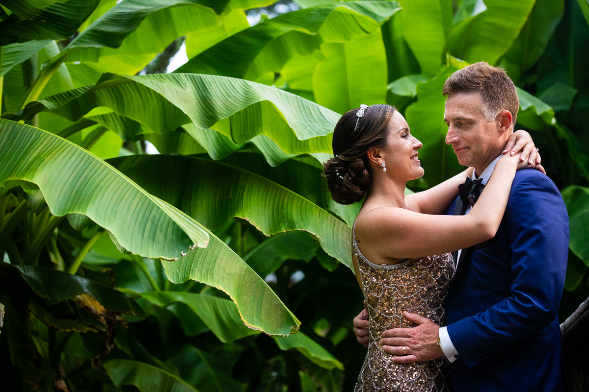 river farm wedding photographer ahs bride and groom smile and hold each other in gardens