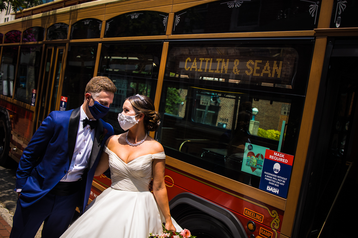 best dc wedding photographer bride and groom wearing matching masks stand in front of dc trolley with personalized sign