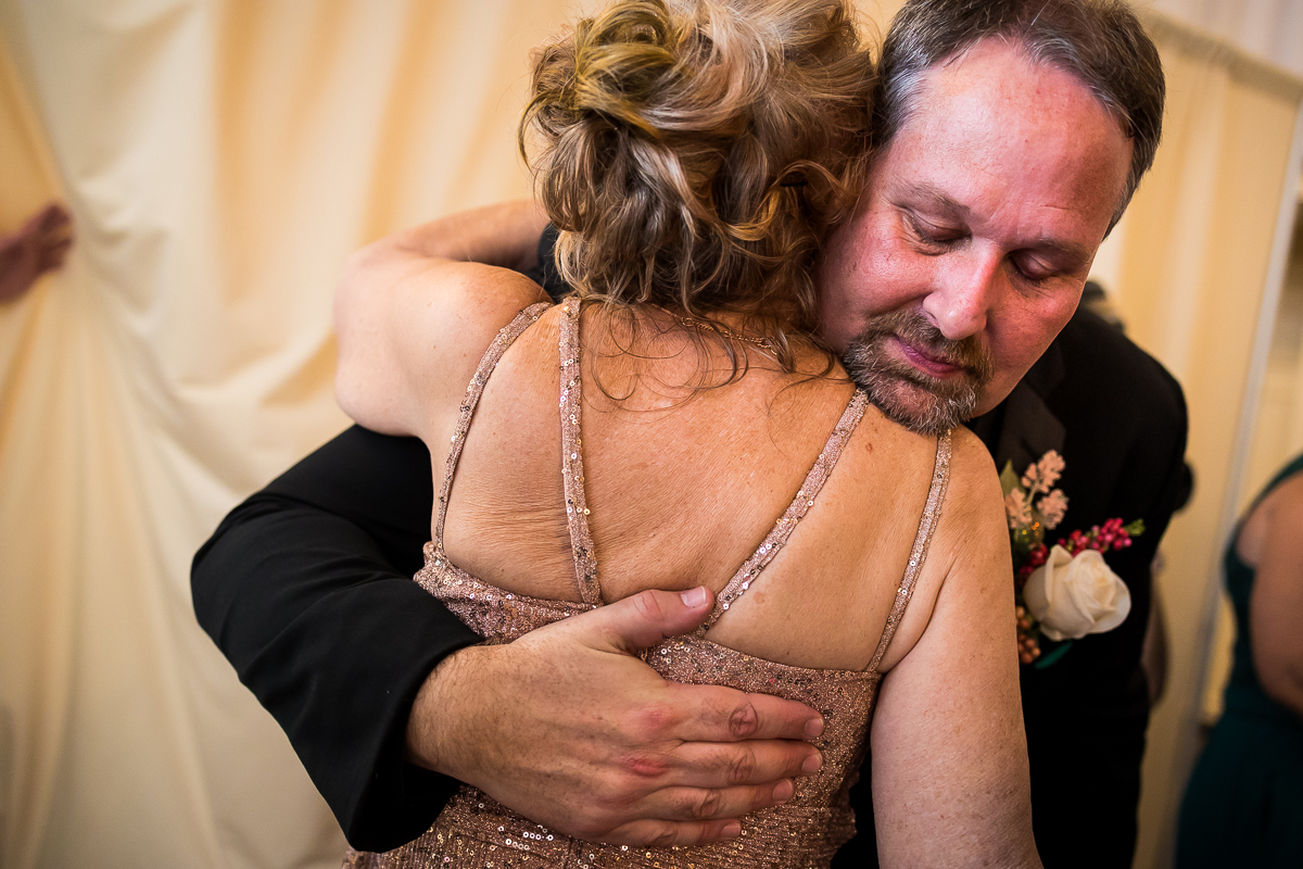 best emotional gettysburg hotel wedding photographer groom hugs guest following ceremony