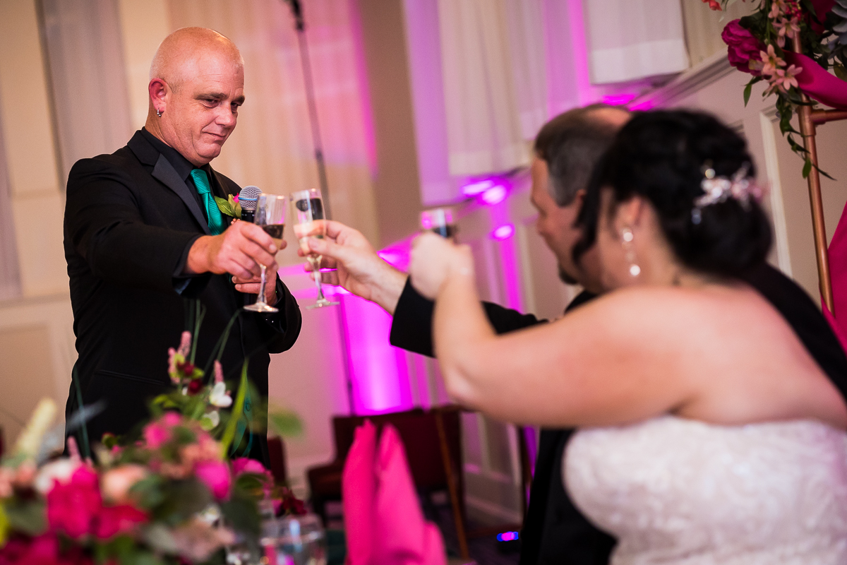 bride and groom toast with best man during wedding speeches at gettysburg hotel ballroom 