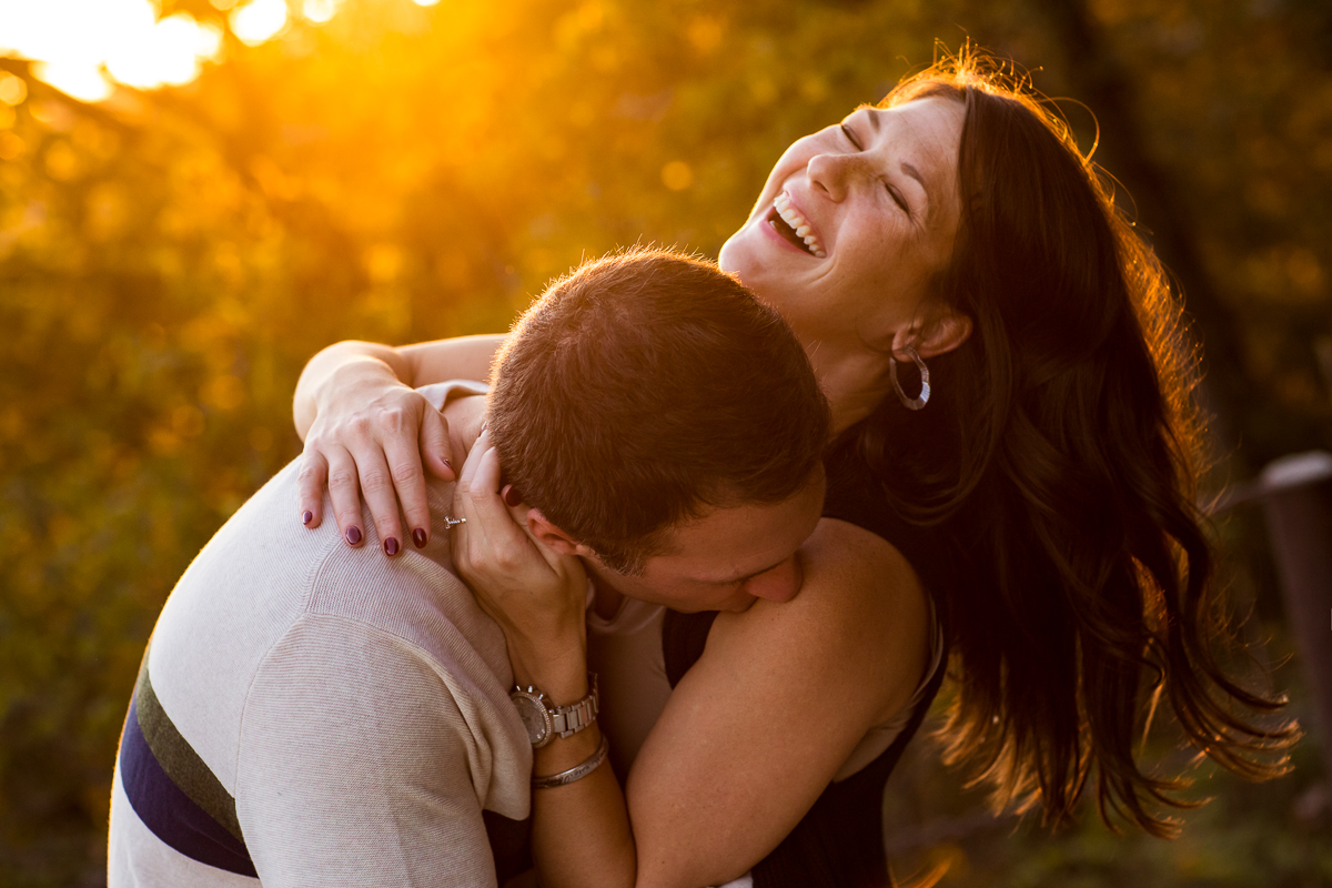 couple laughing and smiling kissing golden hour light harpers ferry va