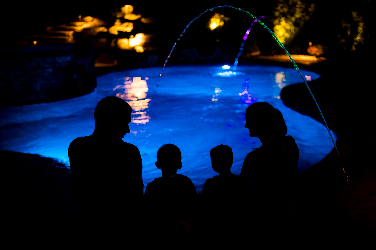 central pa Lehigh valley lifestyle family photographer family sitting by pool at night silhouetted