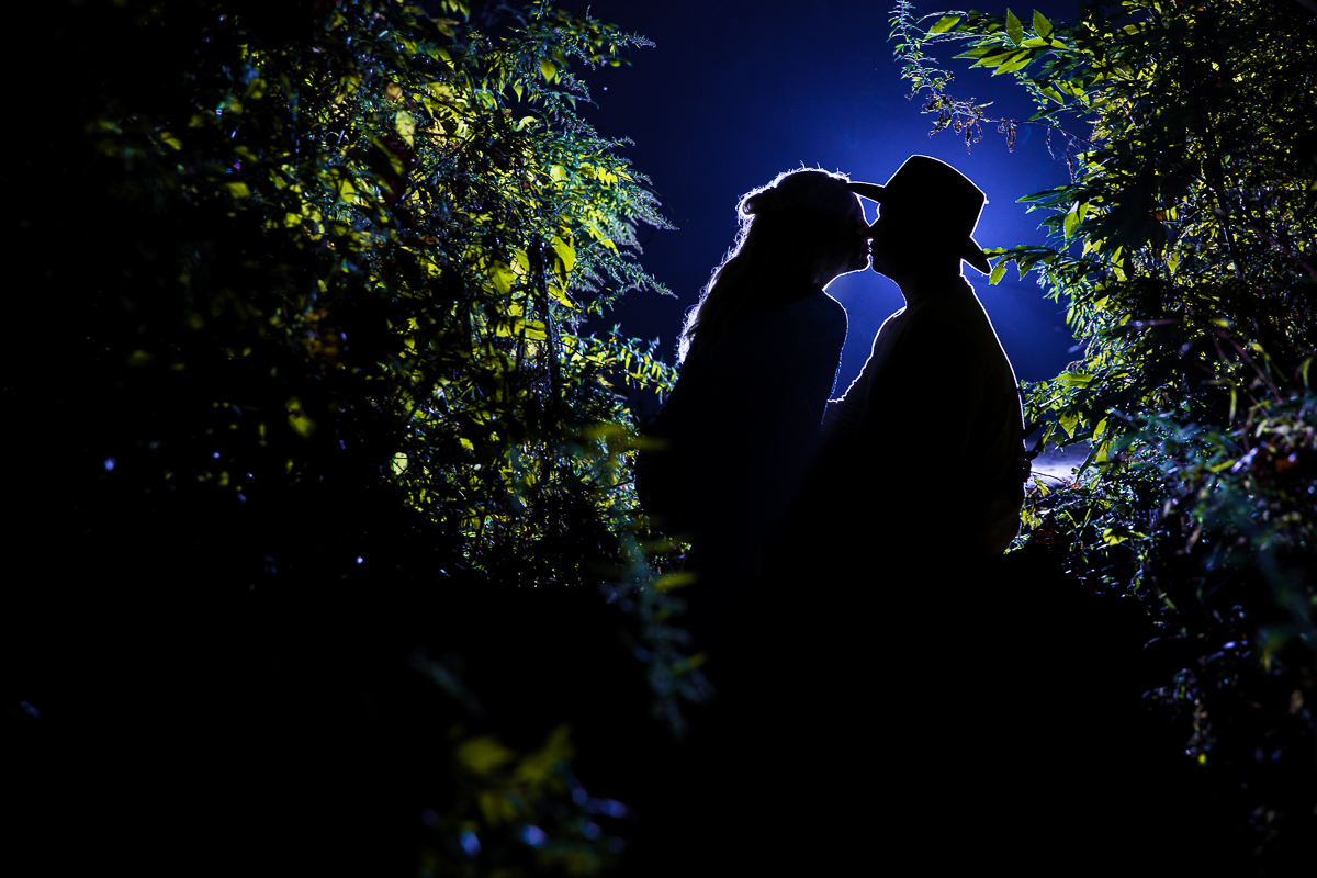 horseback riding and fly fishing engagement couple kissing silhouetted against night sky best creative artistic central pa nj engagement wedding photographer 