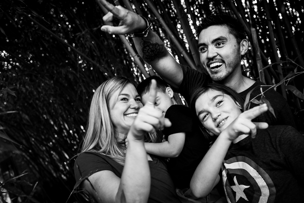 black and white phot of family pointing in different directions smiling at Maryland zoo