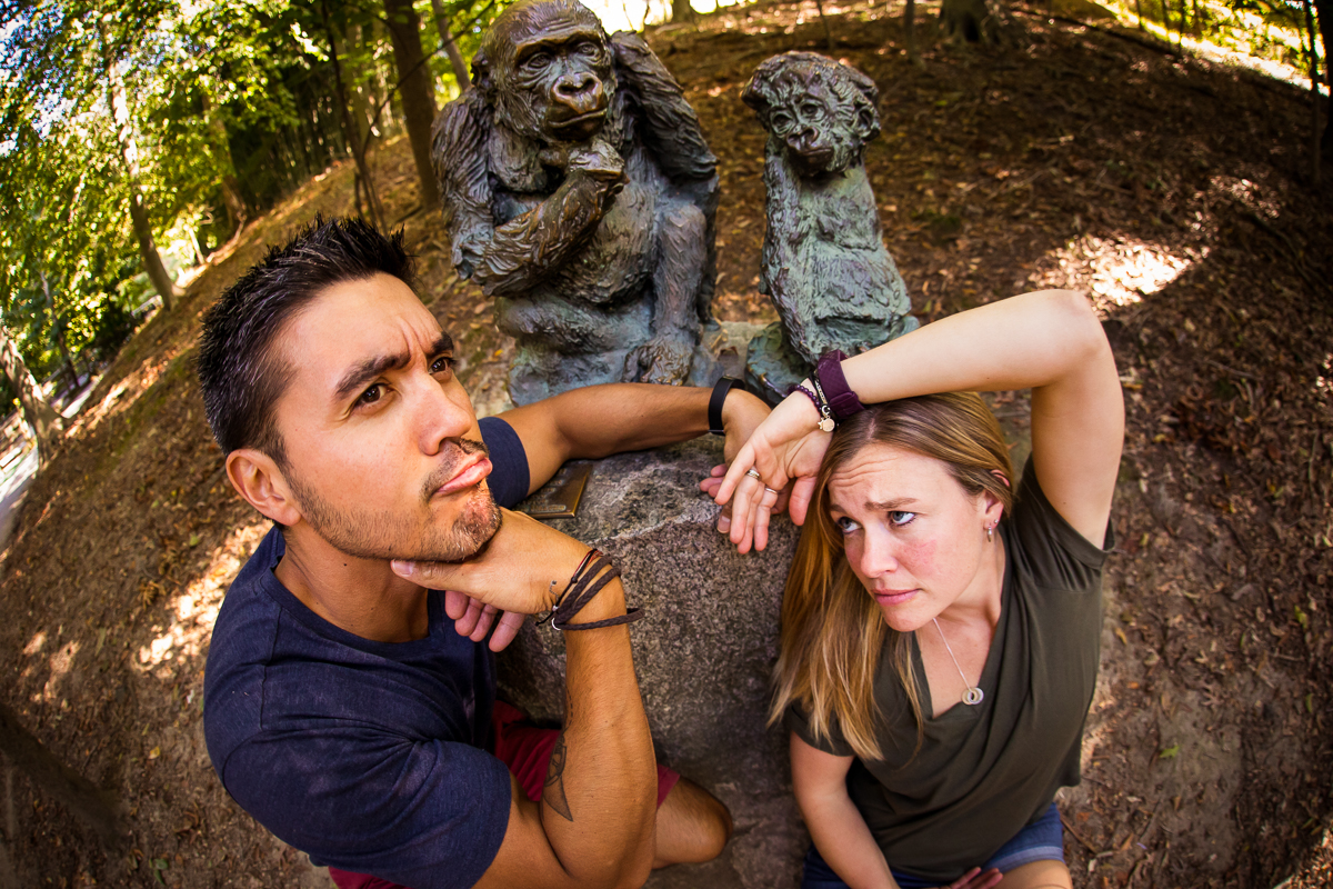 parents imitating monkey poses statues at Maryland zoo