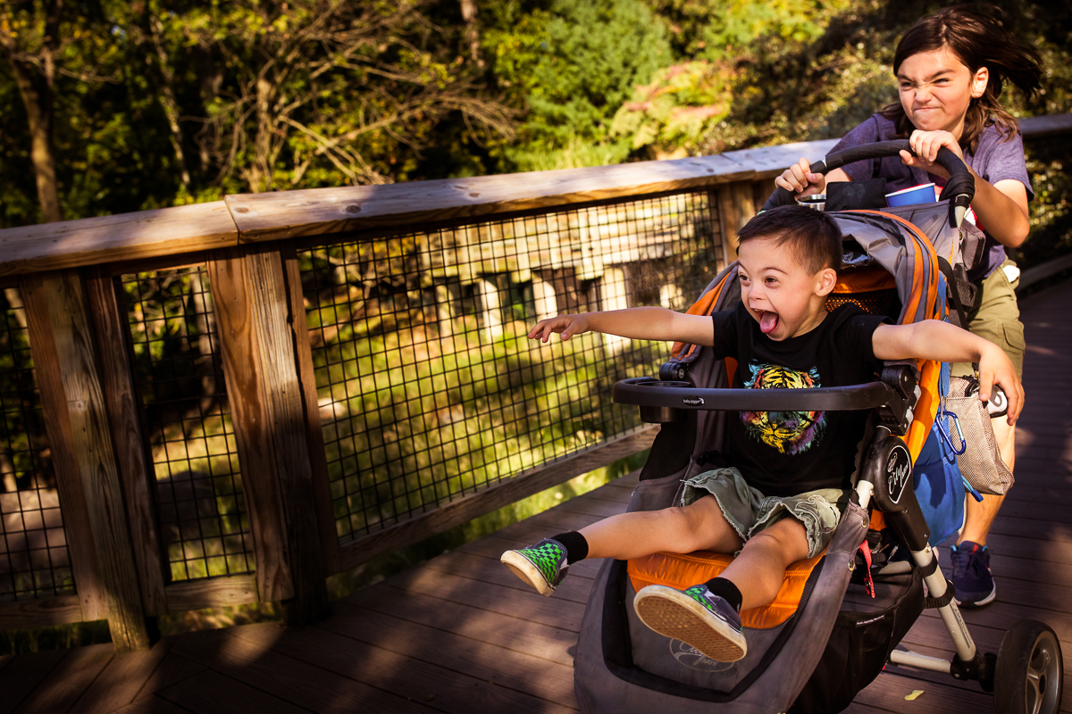 Maryland Zoo in Baltimore Family Lifestyle photographer boy pushing brother in stroller 