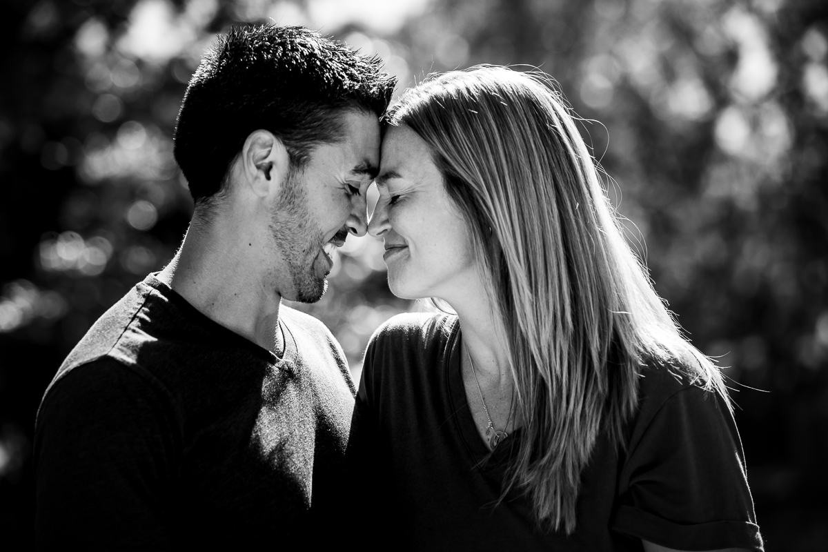 black and white photo of couple touching forehead smiling at each other love photographer md pa