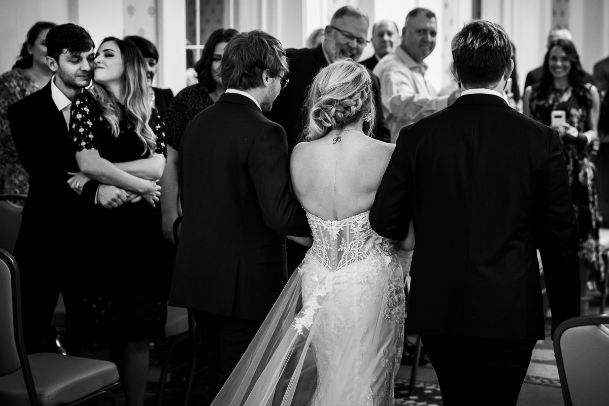 best award winning central pa photographer bride being walked down the aisle by two sons black and white photo 