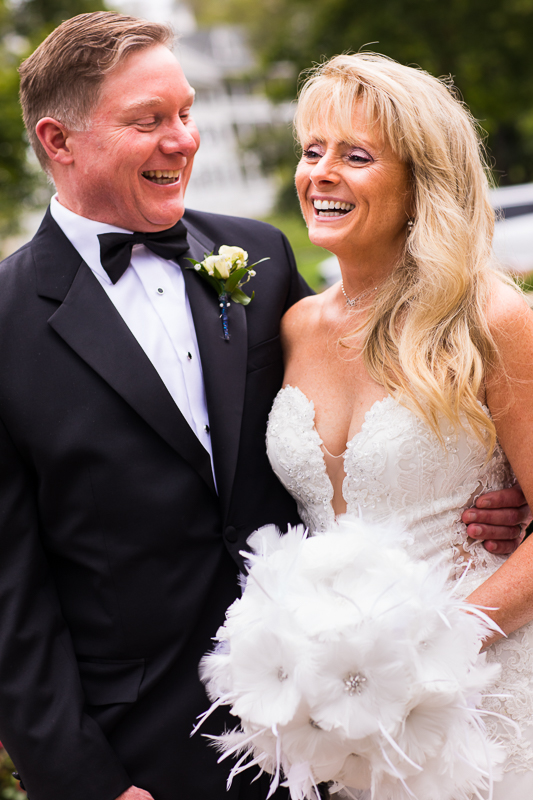 joyful happy couple smiles and laughs during wedding portraits at Omni Bedford Springs central pa best award winning wedding photographer 