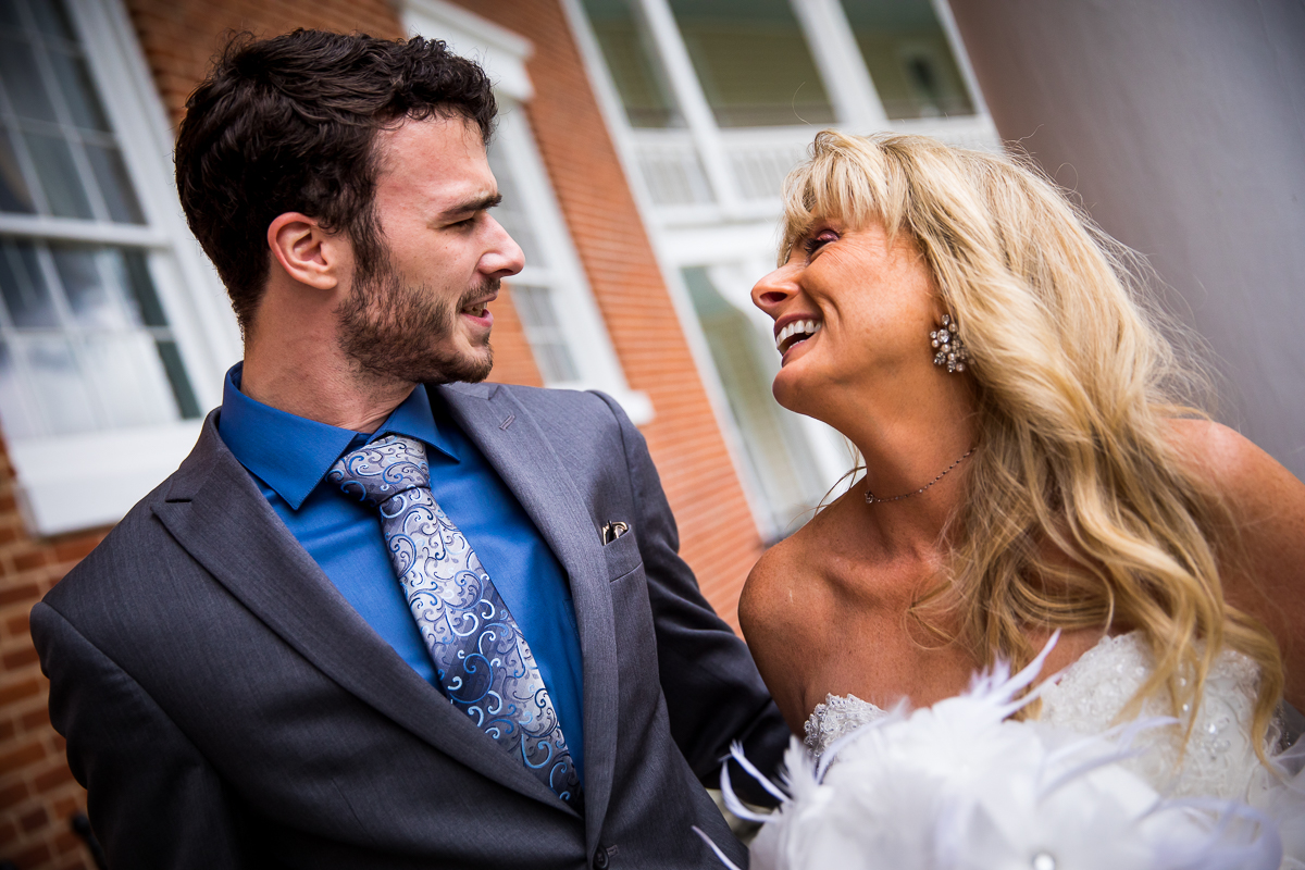 bride and guest smile at each other for portraits at Omni Bedford Springs