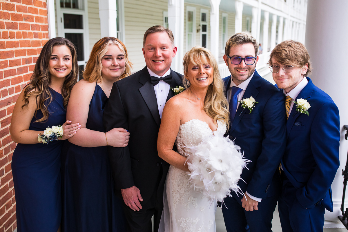 bride and groom with their children traditional family portrait outside Omni Bedford Springs 