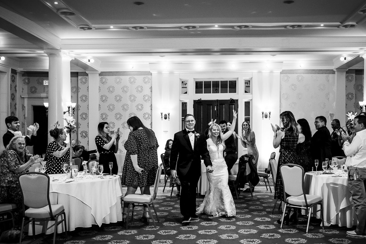 Omni Bedford Springs wedding photographer black and white phot of bride and groom entering colonnade ballroom first time together