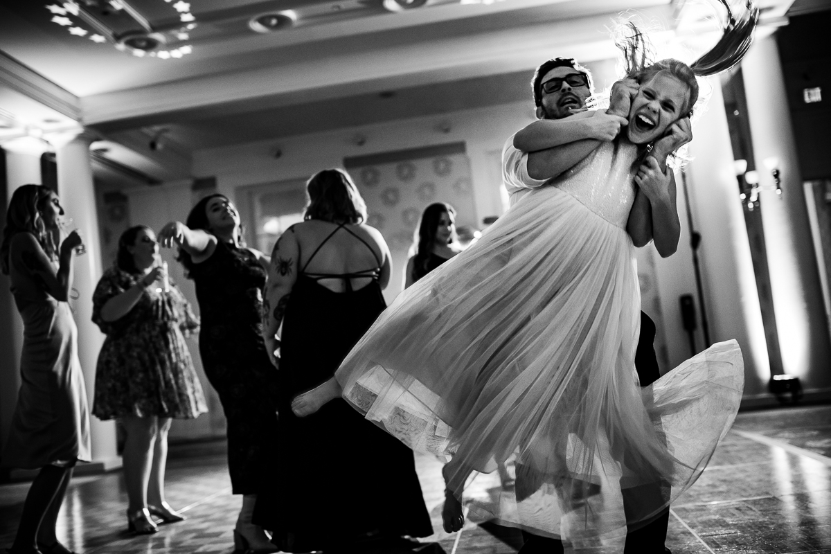 black and white photo of girl being swung around on dance floor candid authentic real life central pa wedding photographer 