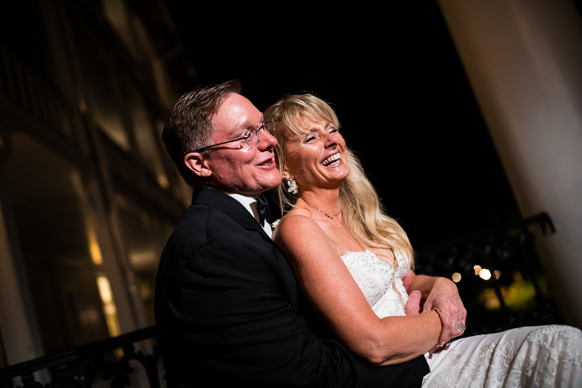 candid authentic natural central pa wedding photographer couple holds each other and laughs during night photos