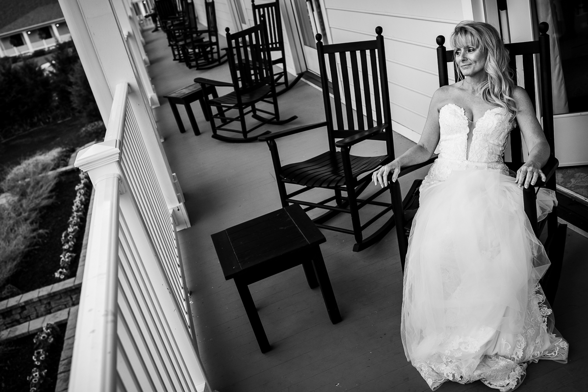 Omni Bedford Springs wedding photographer black and white photo bride sitting on rocking chair after getting ready