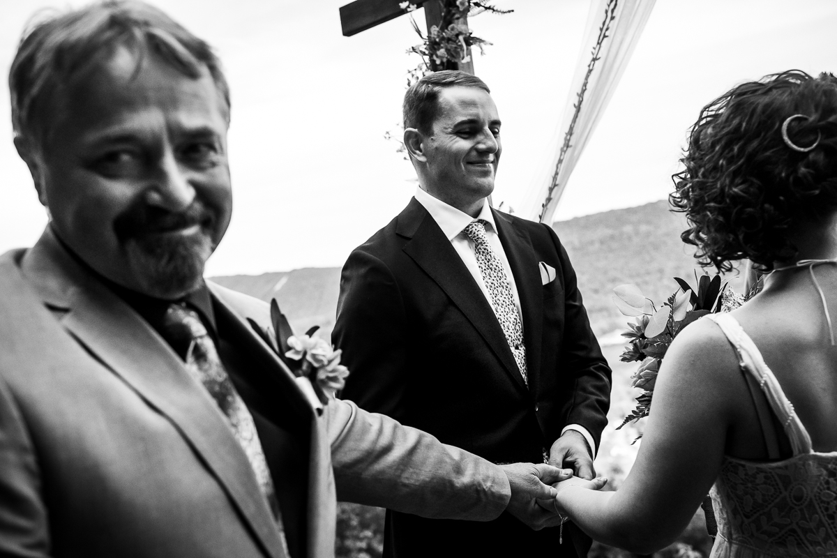 black and white photo of dad giving away bride at wedding ceremony