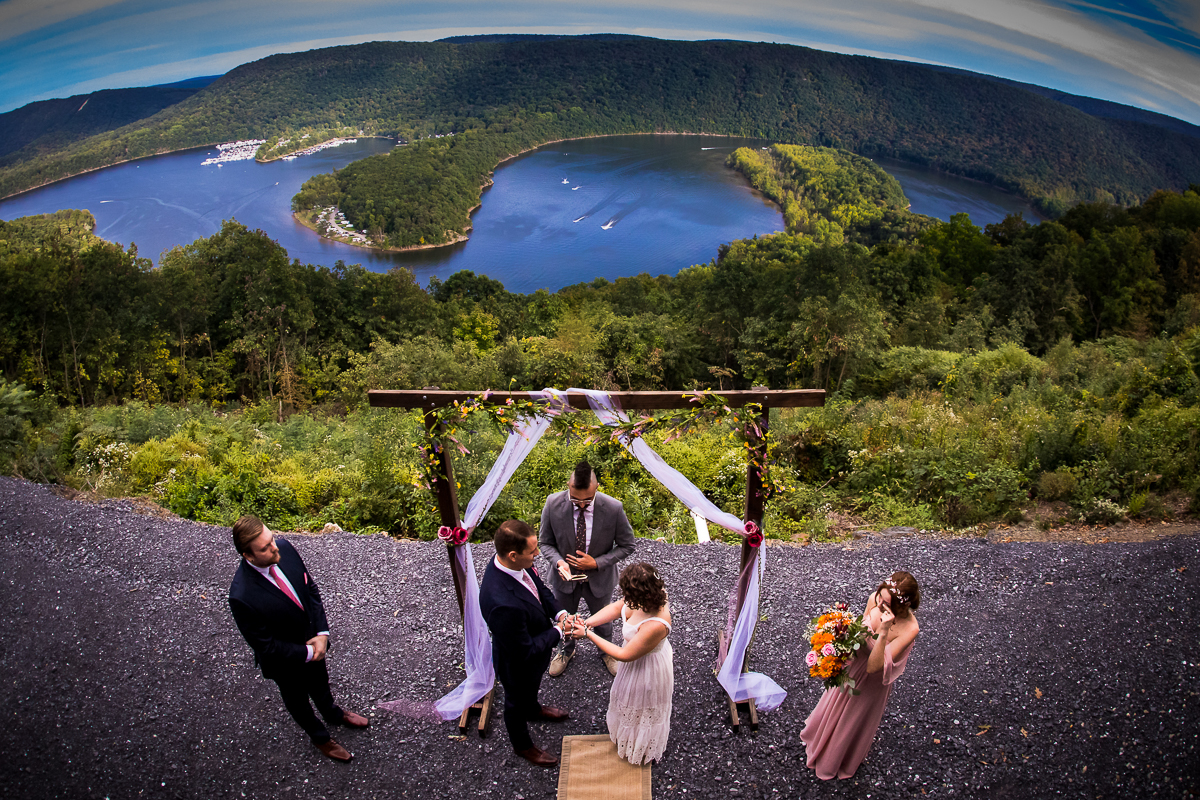 Bella vista raystown lake intimate wedding photographer wedding ceremony under handmade arch with lake view