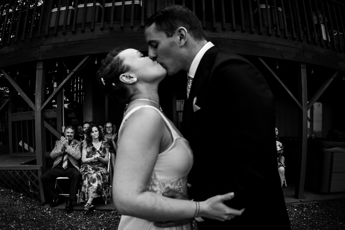 black and white photo of bride and groom first kiss at lake raystown pa wedding photographer
