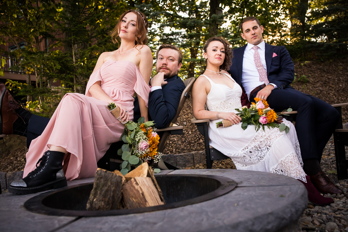 bride and groom posing with wedding party in front of fire pit at raystown lake