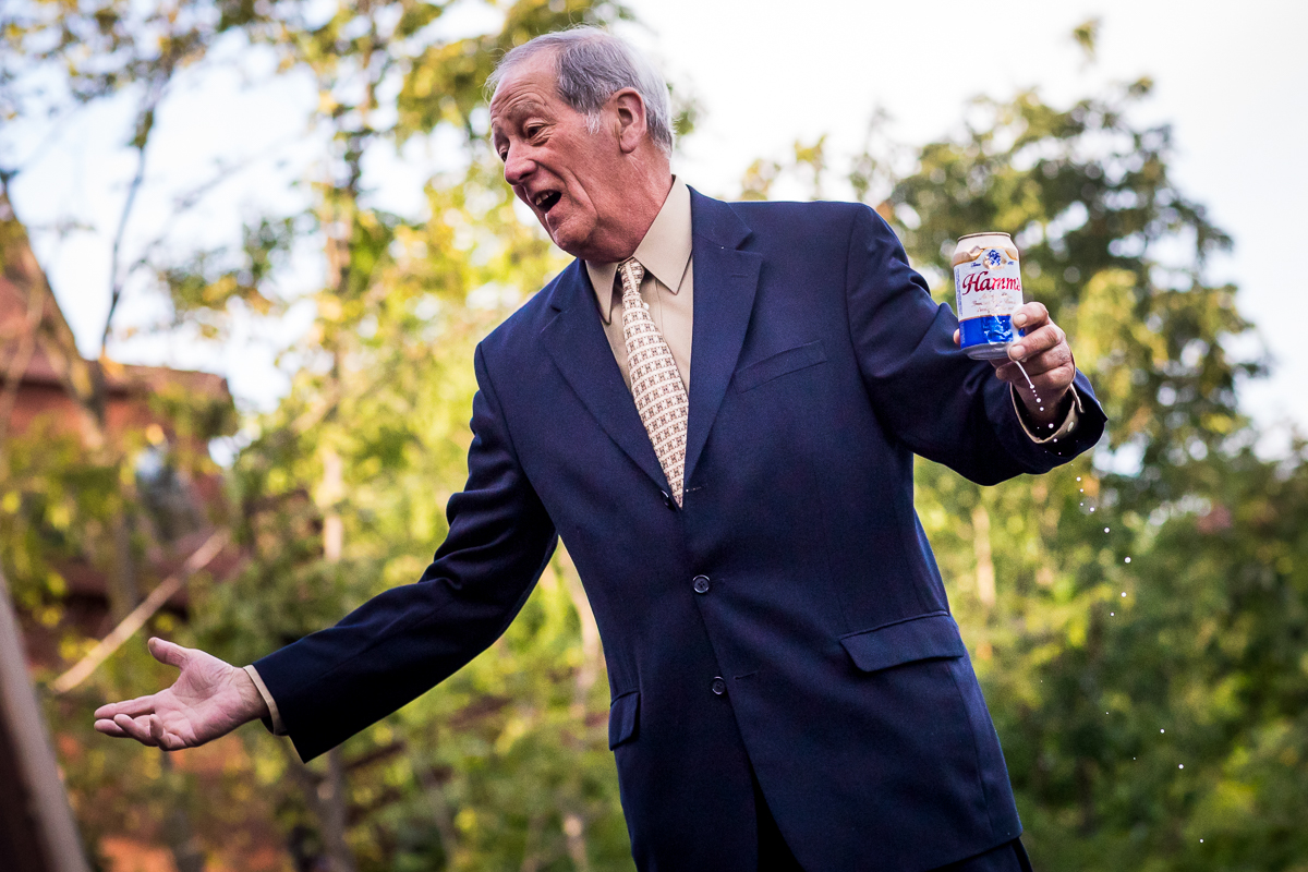 guest talking holding can of beer at wedding reception