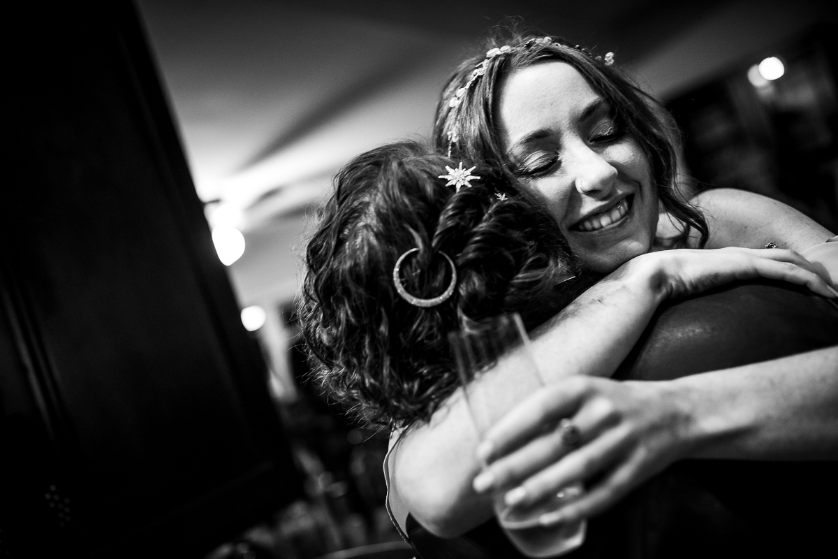 black and white photo of guest hugging bride lake raystown wedding photographer
